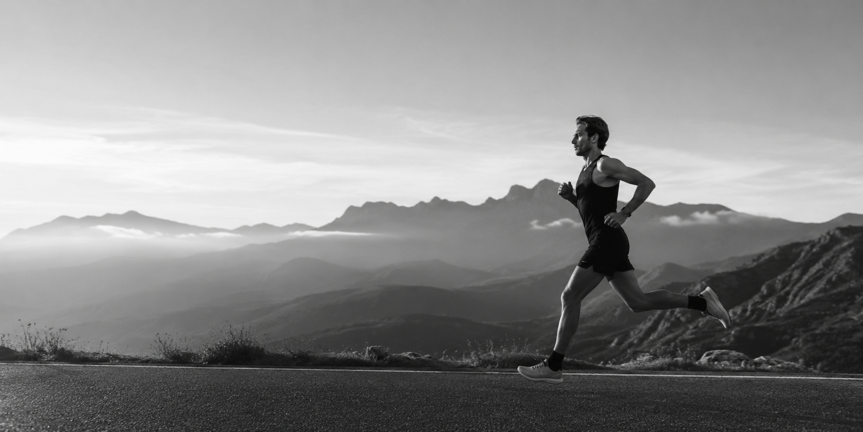 Runner moving along a mountain road in the mountains